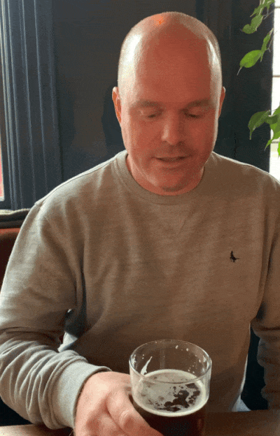 Ben Ellis swigging a beer.